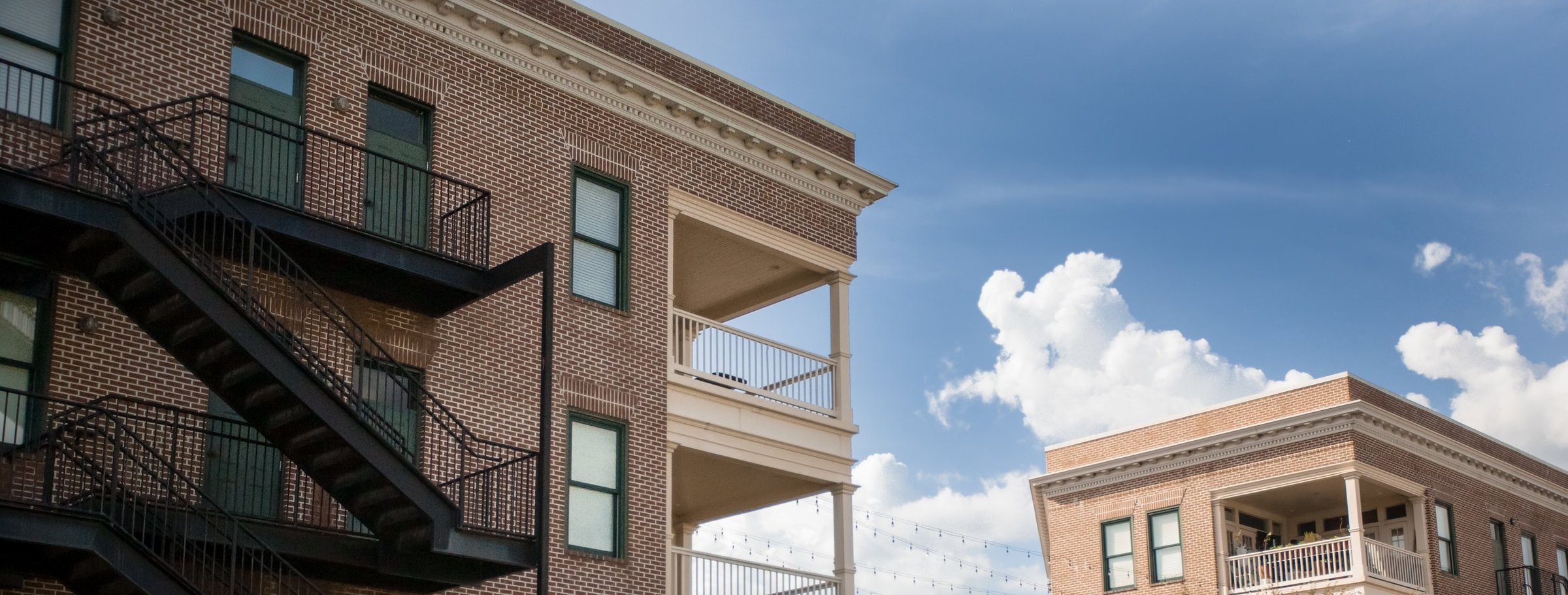 Brick apartment building with iron staircase at Winthrop